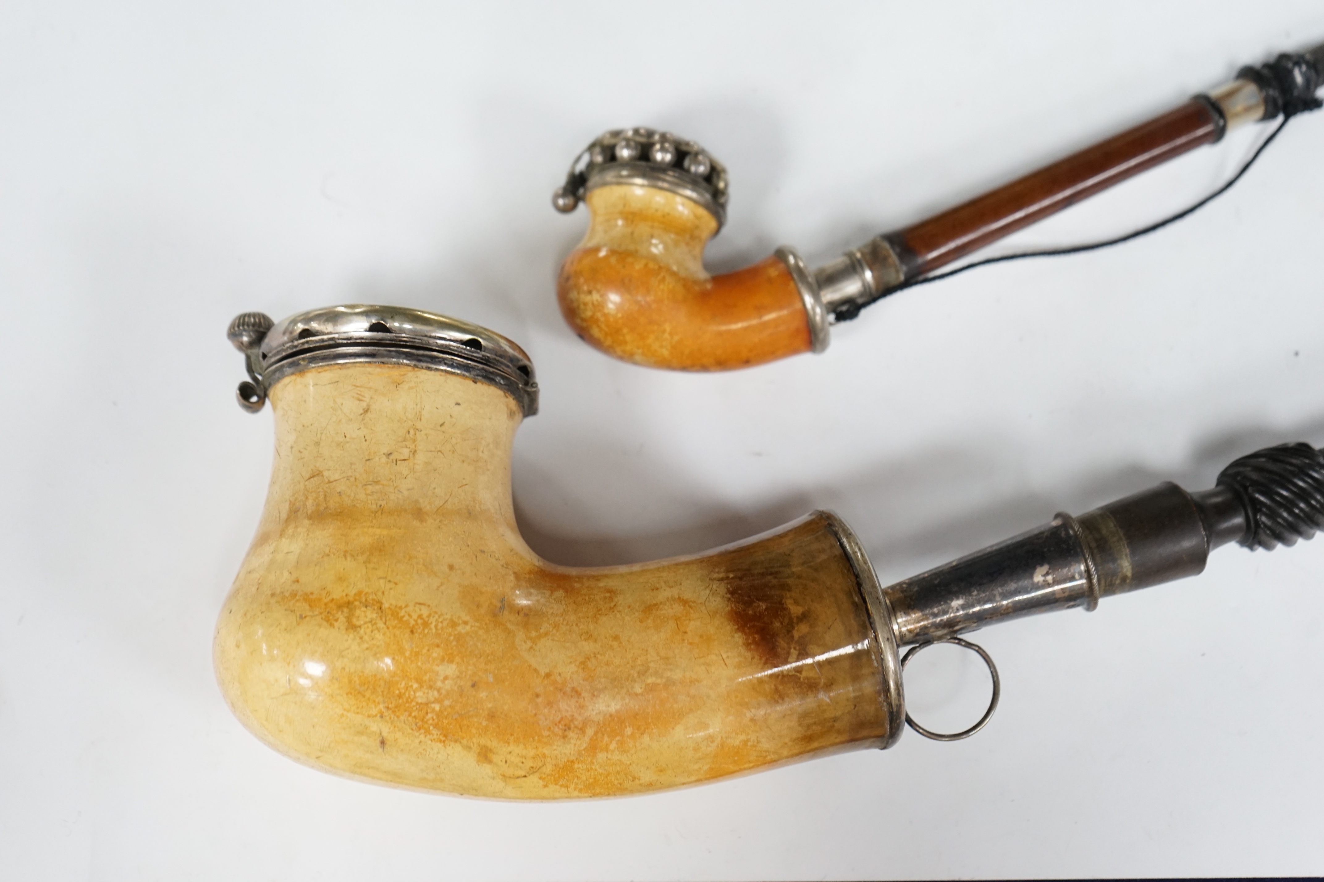 Ten mixed novelty pipes in various sizes with various mixed bowls, together with a small collection of mostly amber mouthpieces and other smoking related items, largest pipe 61cm long